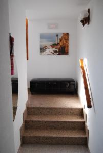 a staircase with a black suitcase on the wall at Hotel Paradís in Torredembarra