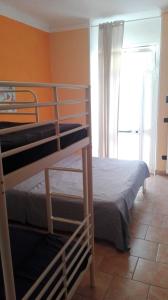 a bedroom with two bunk beds and a window at La casetta dei Marinai in Lerici
