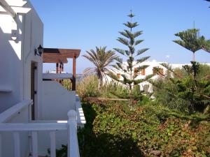 a white house with a staircase and a christmas tree at Ioli Apartments in Naousa