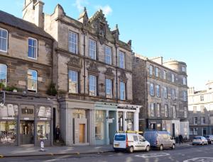 a large building with cars parked in front of it at Destiny Scotland - Broughton St Lofts in Edinburgh