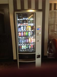 a refrigerator that has some drinks in it at Best Hotel - Montsoult La Croix Verte in Baillet-en-France