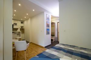 a bedroom with a bed and a chair in a room at Lux Life Apartment in Belgrade