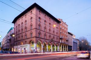 a large red brick building on the corner of a street at Almarossa in Bologna
