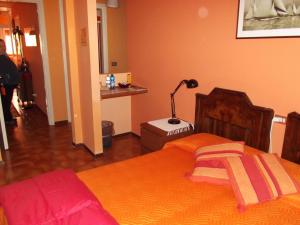 a bedroom with a bed and a lamp in it at Orange House in Varenna +28 photos