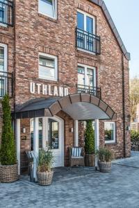 a brick building with an entrance to a hotel at Hotel Uthland in Westerland