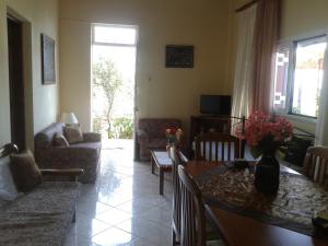 a living room with a couch and a table at Gramvousa's Filoxenia Apartment in Kissamos