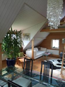 a living room with a couch and a glass table at Neuschwendihof in Rehetobel