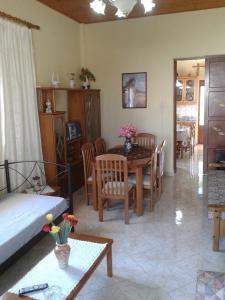 Gramvousa's Filoxenia Apartment في كيساموس: غرفة معيشة مع سرير وطاولة وكراسي