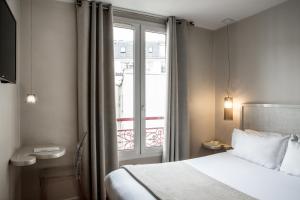 เตียงในห้องที่ Le Quartier Bercy-Square