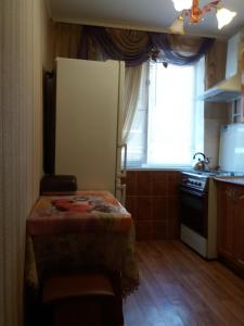 a small kitchen with a table and a window at Daily apartment Sumy in Sumy