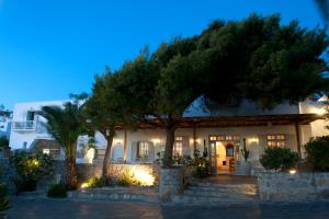 a building with a tree in front of it at Elena Hotel Mykonos in Mikonos