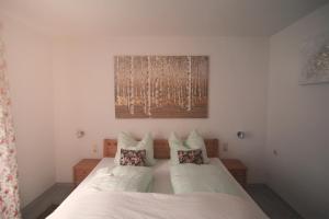 a bedroom with a bed with two pillows at Lamai's Pension in Konstanz