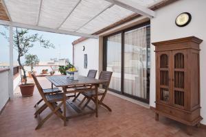 a dining room with a table and chairs on a balcony at Le Terrazze di Angela in Marina di Ragusa