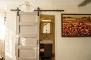 a bathroom with a door and a painting on the wall at B&B Aan het Park Eindhoven in Eindhoven