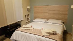 a bedroom with a bed with two towels on it at B&B VIA VENETO in Crotone