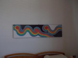 a painting of a rainbow on a wall at Sa 'E Jana in Orgosolo