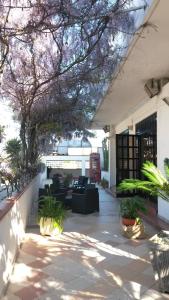 a patio with a red phone booth on a building at Hotel Calla' in Policoro