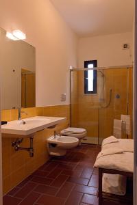 a bathroom with two toilets and a sink and a shower at Agriturismo Poggio Agli Ulivi in Riotorto +40 photos