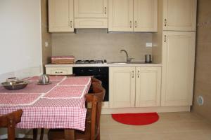 a kitchen with a table and a sink and a stove at B&B Stelle Della Daunia in San Severo