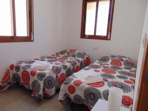 a room with two beds and two windows at Duplex 8 in Puerto de Mazarrón +5 photos