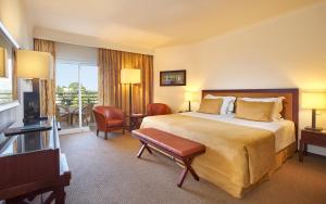 a hotel room with a bed and a television at PortoBay Falesia in Albufeira