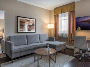 uma sala de estar com um sofá e uma mesa em The Lord Nelson Hotel & Suites em Halifax