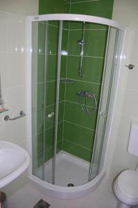 a shower with a glass door in a bathroom at Penzion Pri Slovenc in Dol pri Ljubljani