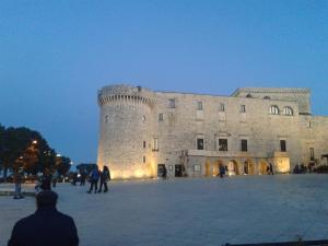 a large castle with people standing in front of it at Dimora delle Badesse in Conversano