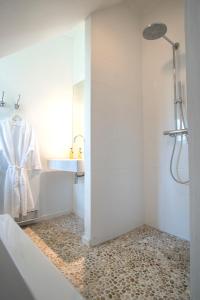 a white bathroom with a shower and a sink at B&B Buitenplaats Natuurlijk Goed in Oosterwolde