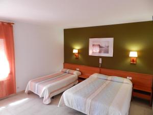 Postel nebo postele na pokoji v ubytování Hotel El Castell