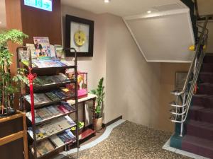 a book store with a shelf of books and stairs at Fu Chang Hotel in Taipei
