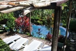 a group of white chairs sitting on a patio at Oasis Marigot in Marigot Bay