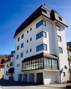 a large white building with a lot of windows at Hotel Blume Post in Albstadt