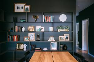 a room with a wooden table and a shelf with books at Noon on Sunset Hill in Los Angeles