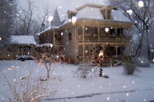 a house with a snow covered yard in front of it at Fallen Tree Farm Bed and Breakfast in Carlisle