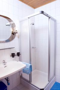 a white bathroom with a shower and a sink at Frühstückspension Zur Blauen Traube in Yspertal