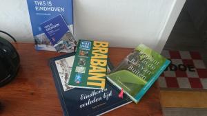 three books sitting on top of a table at B&B Aan het Park Eindhoven in Eindhoven