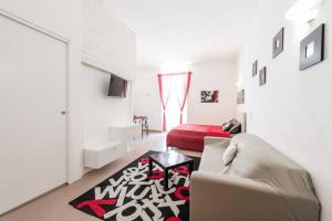 a living room with a couch and a red bed at Little Home in Trani