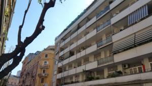 an apartment building with balconies on a street at La Casa Del Pigneto in Rome