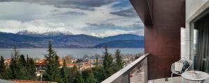 a balcony with a view of a lake and mountains at Saz City Life Boutique Hotel in Ioannina