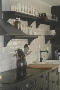 a kitchen with a sink and a counter with utensils at Alvaret Hotel & Hostel in Löttorp