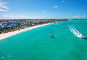 an aerial view of a boat in the water on a beach at Beaches Turks and Caicos Resort Villages and Spa All Inclusive in Providenciales