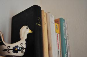 a book holder with a bird on top of books at Agiasos Tranditional House in Agiásos