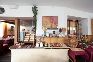 a restaurant with a counter with food on it at Gasthof Moarwirt in Colle Isarco