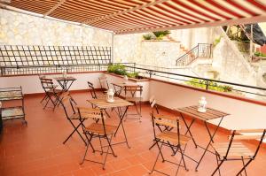a group of tables and chairs on a patio at B&B Cetara Amalfi Coast in Cetara