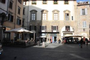 eine Gruppe von Menschen, die vor einem Gebäude eine Straße hinuntergehen in der Unterkunft Fiamma Apartment in Florenz