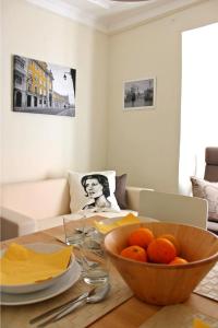 a dining room table with a bowl of oranges on it at Window to Lisboa I in Lisbon