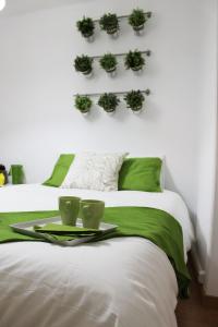 a bedroom with two beds with a tray with cups and plants at Window to Lisboa II in Lisbon