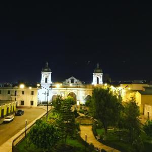 a large building with two towers at night at Hotel Plaza San Antonio Arequipa in Arequipa