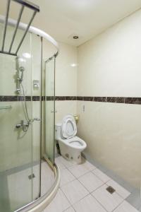a bathroom with a toilet and a glass shower at Eureka in Tainan